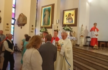 Ksiądz udzielający komunii wiernym 